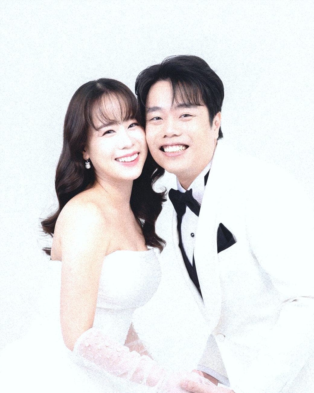 Witita and Sorratat cheek to cheek in white tuxedo and gown