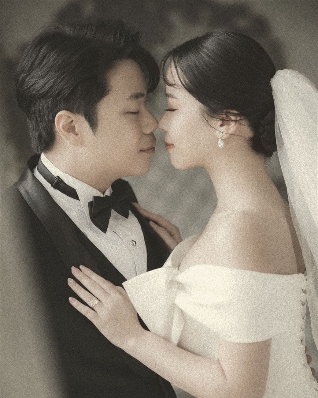 Witita and Sorratat, forehead to forehead in tuxedo and gown