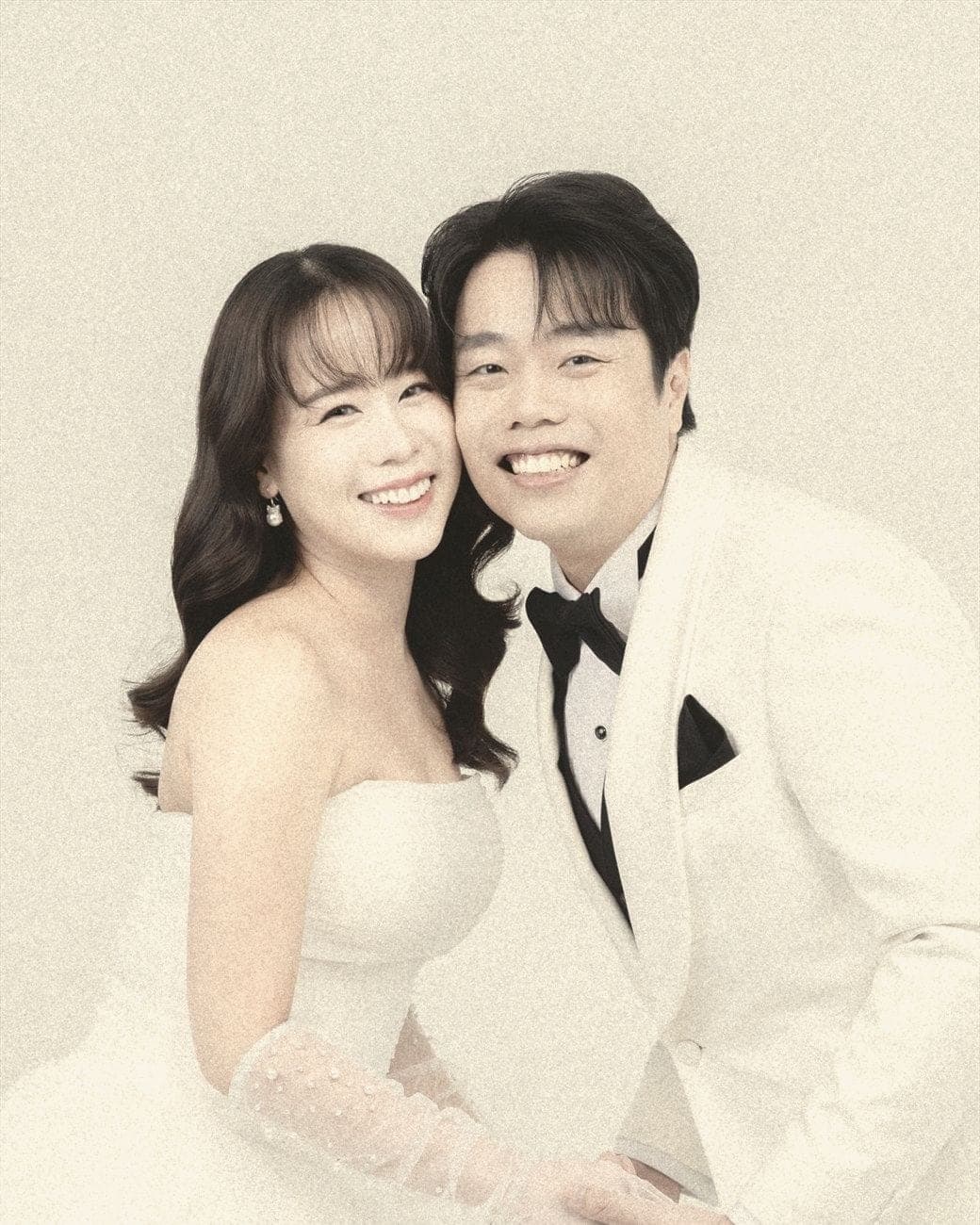 Witita and Sorratat cheek to cheek in white tuxedo and gown