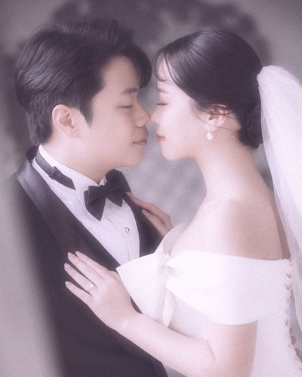 Witita and Sorratat, forehead to forehead in tuxedo and gown