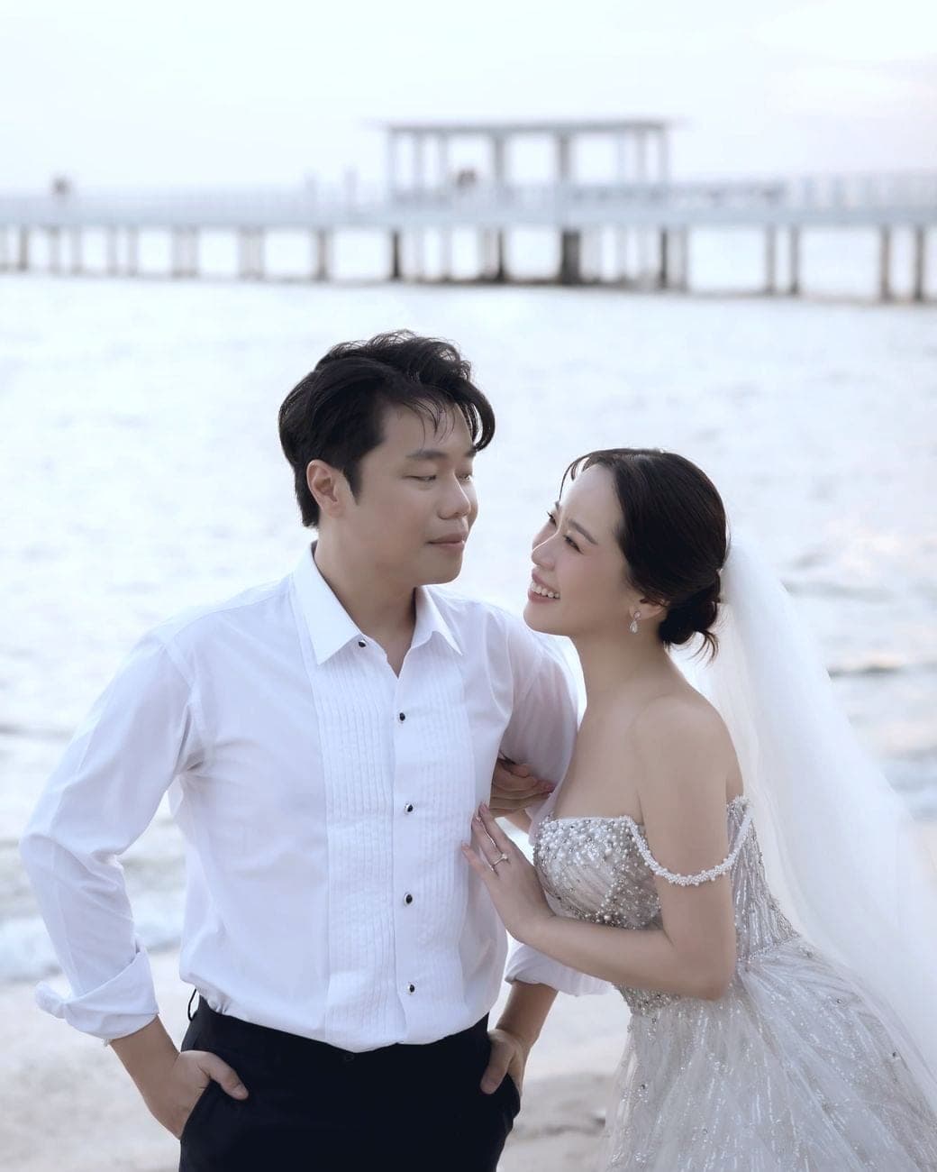 Witita leaning on Sorratat's shoulder on the beach